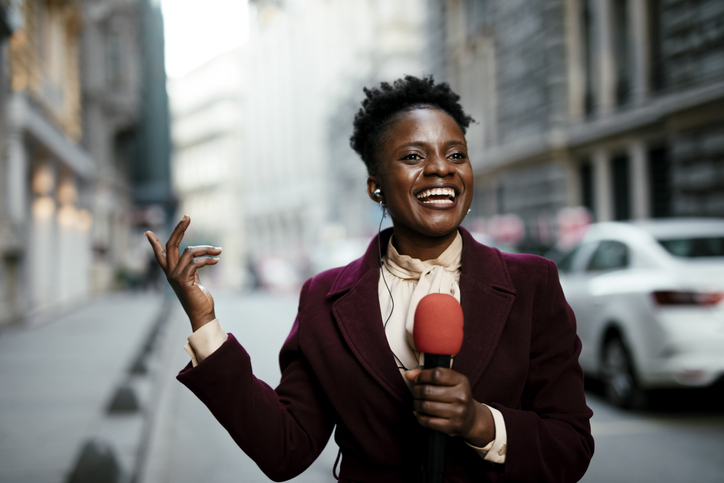 African female news reporter in live broadcasting.