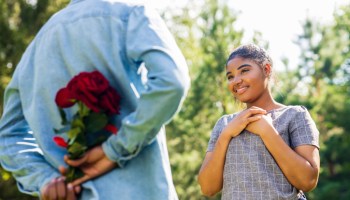 Smiling african couple at romantic picnic in summer park dation at sunny day