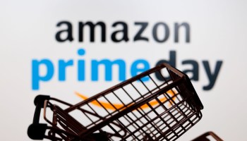 In this photo illustration, a shopping cart is seen in front...