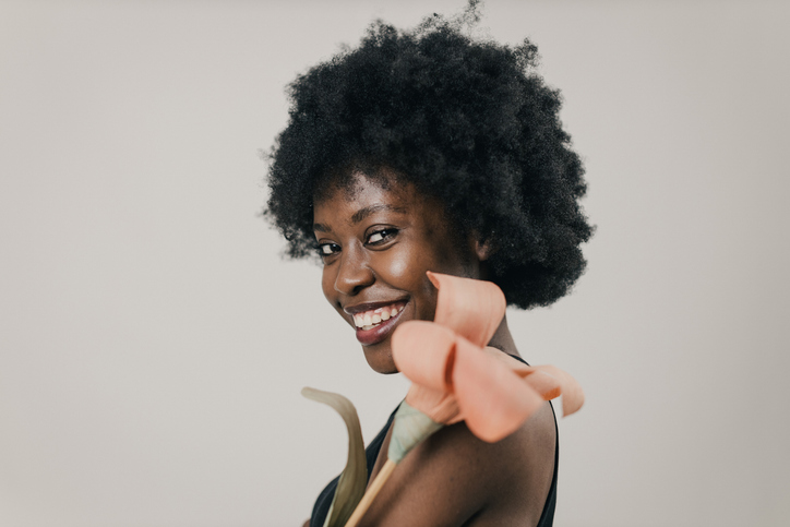 Beautiful Young Black Woman With Afro Hairstyle Taking Care of Skin